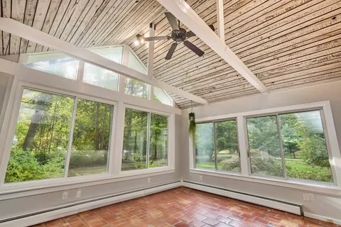 a view of empty room with large windows