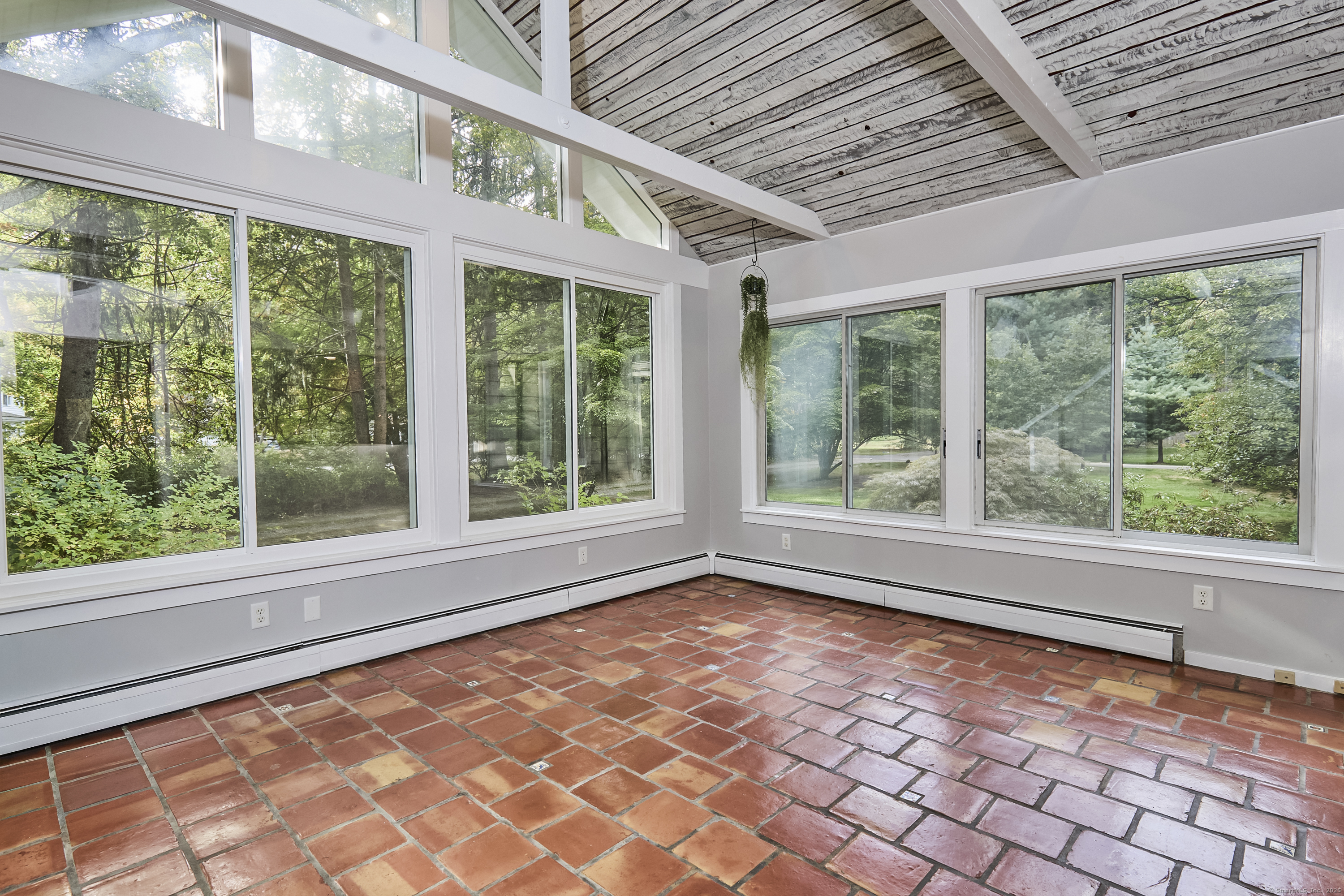 4 Colony Road Weston, CT 06883 - Photo 5 of 39 a view of empty room with wooden floor and fan