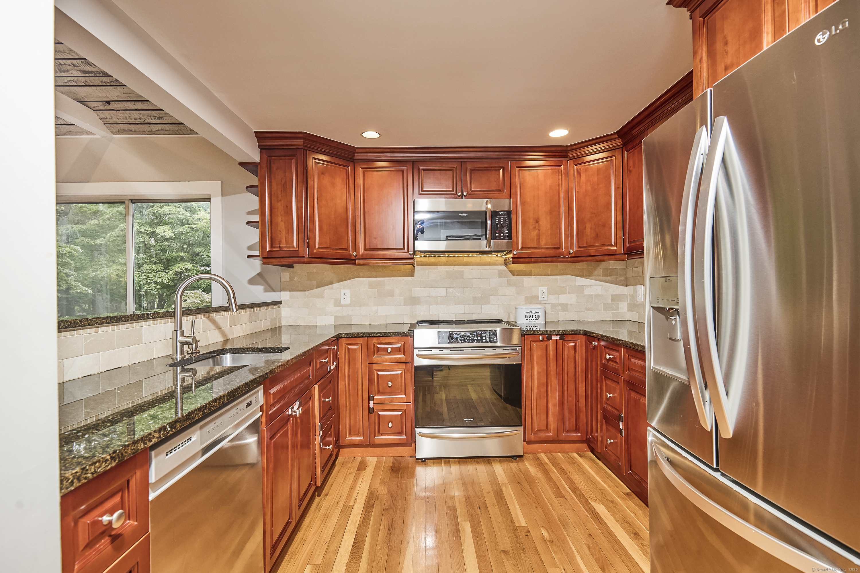 4 Colony Road Weston, CT 06883 - Photo 10 of 39 a kitchen with stainless steel appliances granite countertop a sink stove and refrigerator