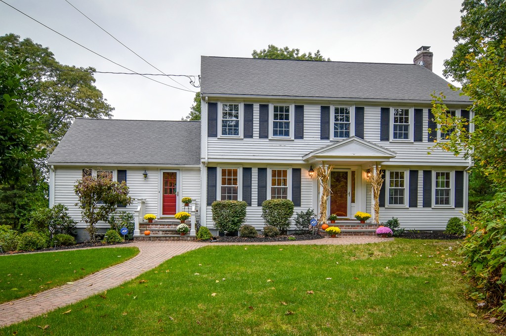 a front view of a house with a yard table and chairs