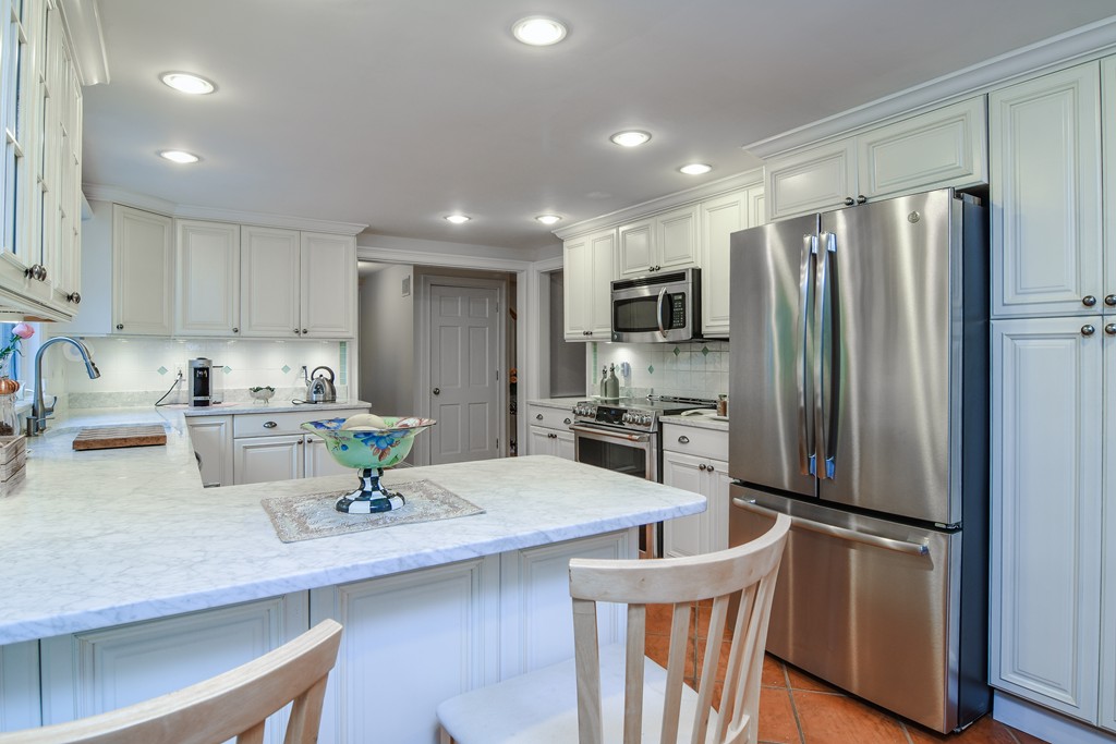 16 Tower Drive Dover, MA 02030 - Photo 12 of 42 a kitchen with kitchen island a counter top space stainless steel appliances and cabinets