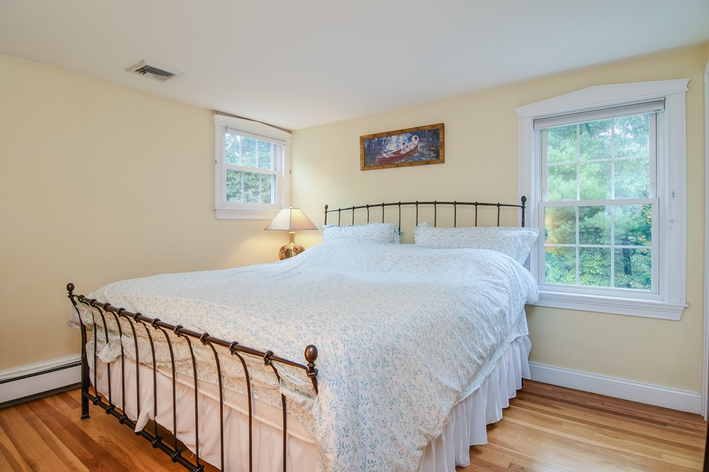 16 Tower Drive Dover, MA 02030 - Photo 23 of 42 a bed sitting in a bedroom next to a window