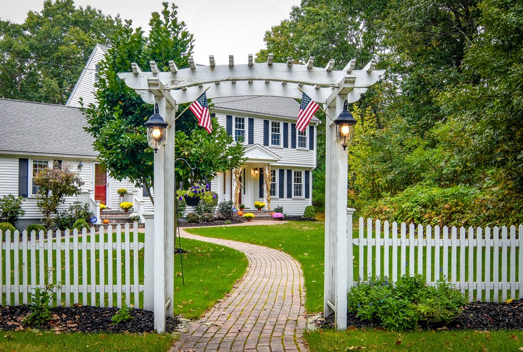 16 Tower Drive Dover, MA 02030 - Photo 29 of 42 a front view of a house with a garden and pathway