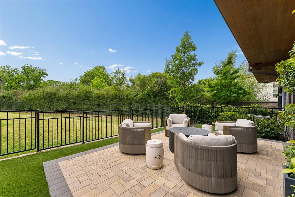 a view of a roof deck with chair and potted plants
