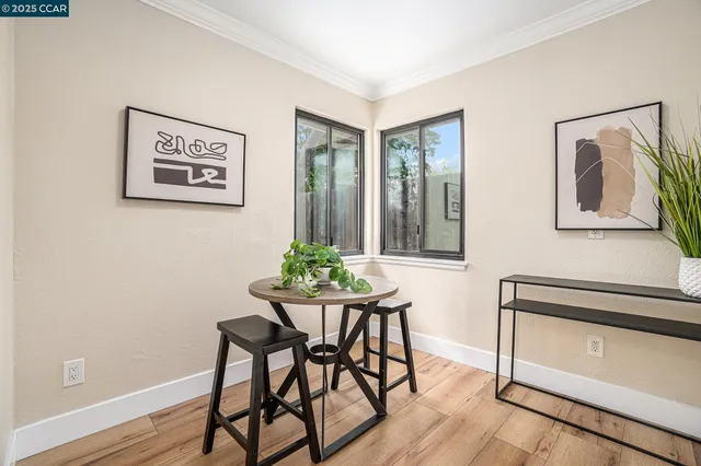 a view of a workspace room with furniture and wooden floor