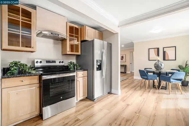 a kitchen with stainless steel appliances granite countertop a stove and a refrigerator