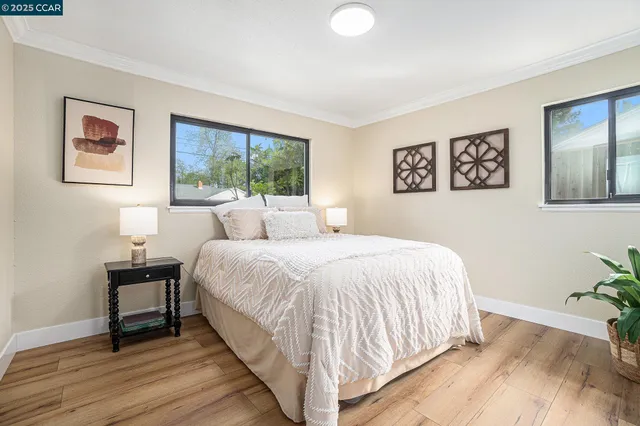 a bedroom with a bed and a painting on the wall