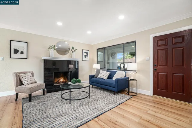 a living room with furniture and a fireplace