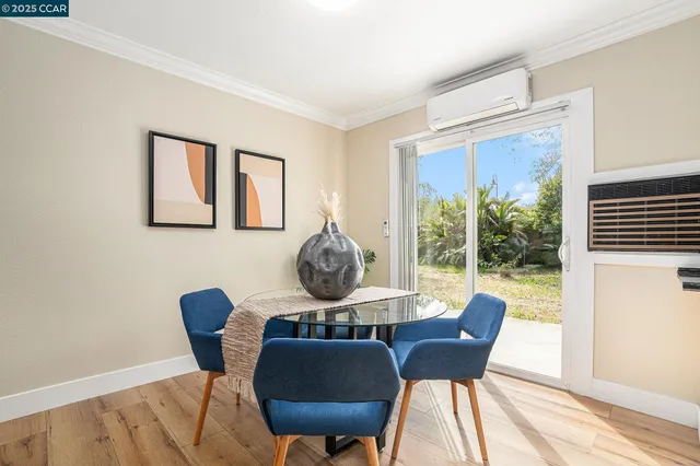 a dining room with furniture and wooden floor