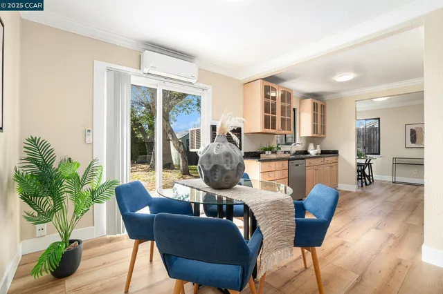 a dining room with furniture window and wooden floor