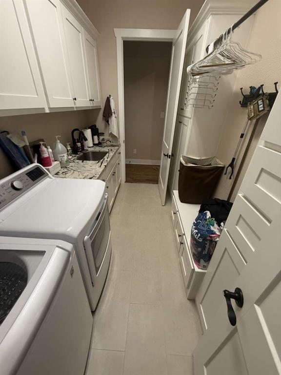 125 Lucky Ridge Lane Boyd, TX 76023 - Photo 14 of 29 Washroom with cabinet space, washing machine and clothes dryer, and light tile patterned floors