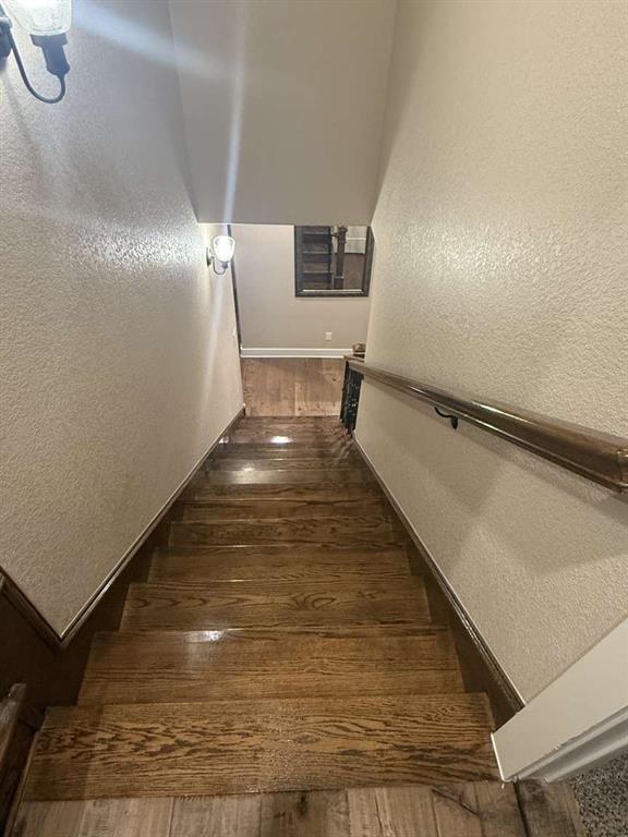 125 Lucky Ridge Lane Boyd, TX 76023 - Photo 25 of 29 Stairs featuring hardwood / wood-style flooring and a textured wall
