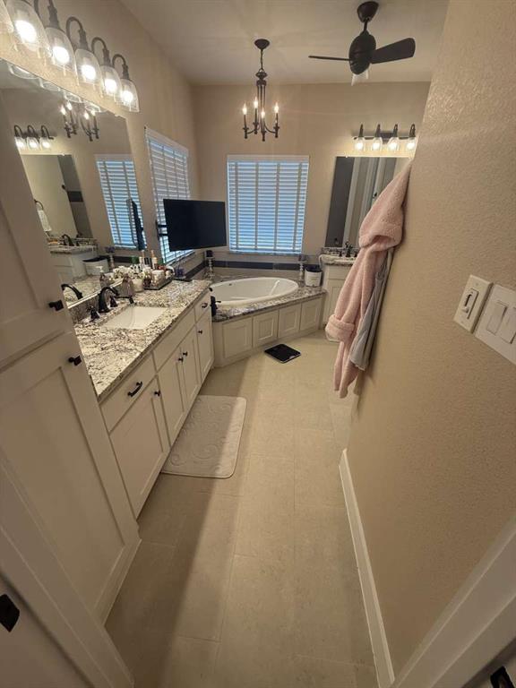 125 Lucky Ridge Lane Boyd, TX 76023 - Photo 10 of 29 Full bathroom with a bath, vanity, a chandelier, ceiling fan, and tile patterned flooring