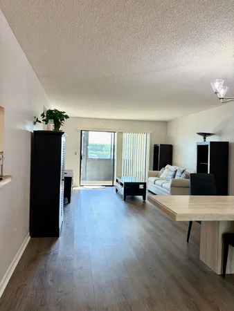 a table and chairs in a room with an open kitchen