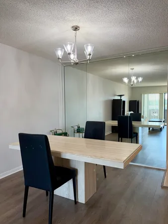 a living room with furniture a rug and white walls