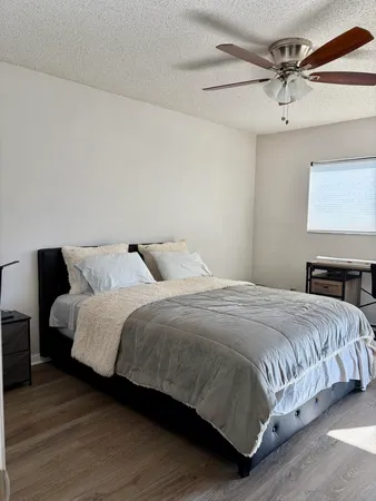 a bedroom with a bed and a mirror