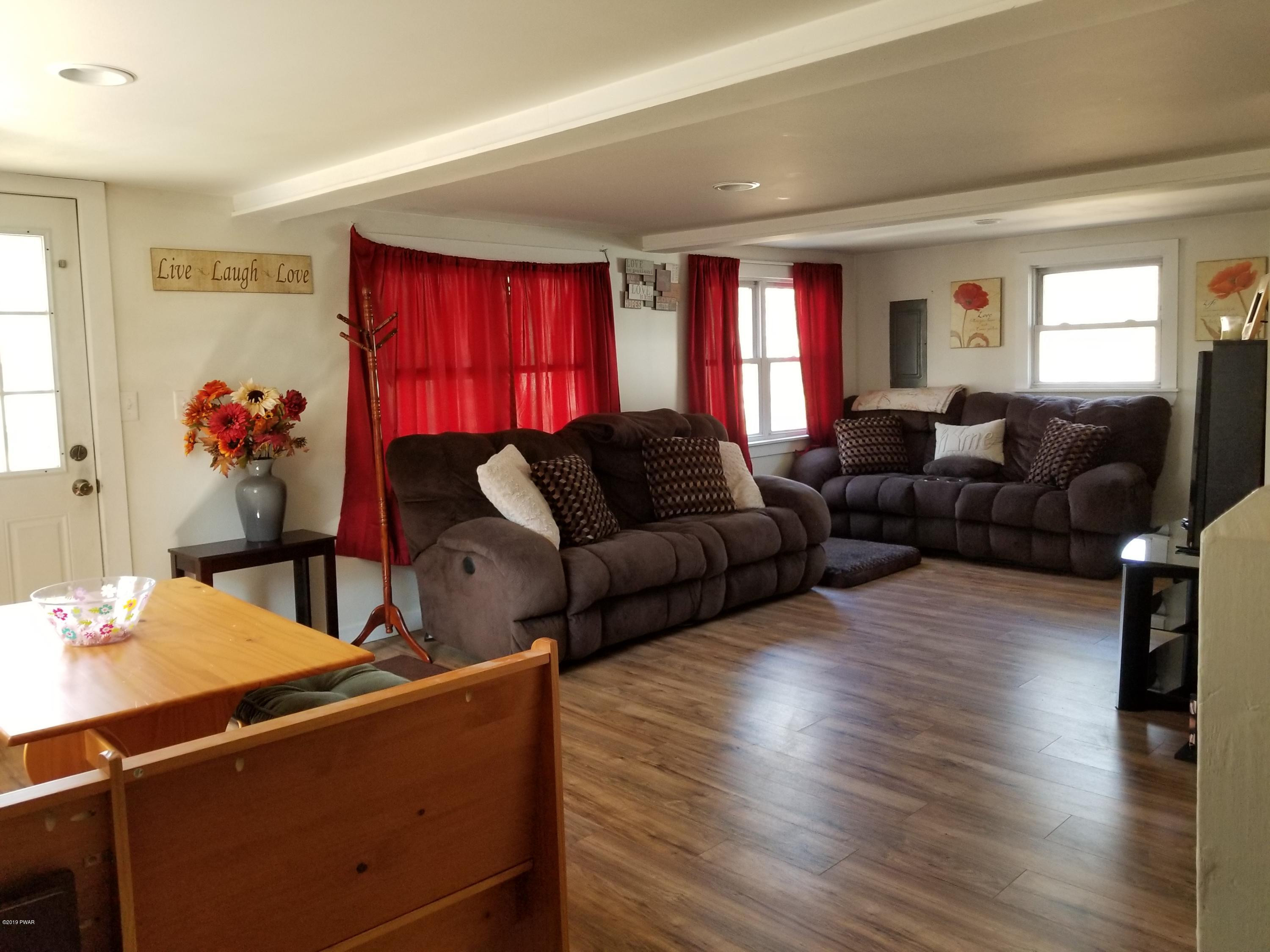 108 Red Pine Road Dingmans Ferry, PA 18328 - Photo 5 of 15 a living room with furniture and wooden floor