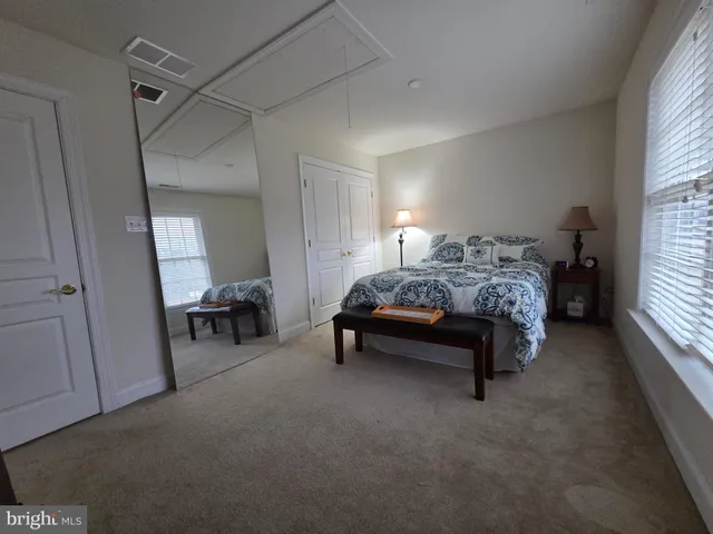 a living room with furniture and a mirror