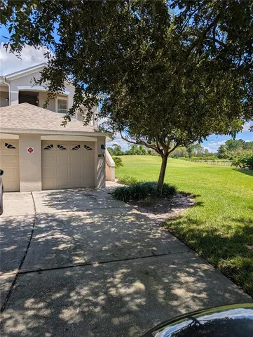a view of a house with a yard and garage