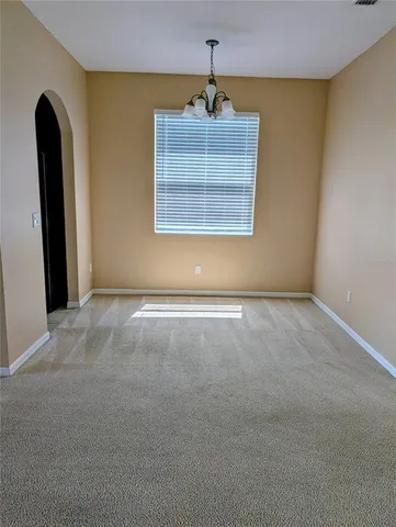 a view of an empty room with window and painted walls