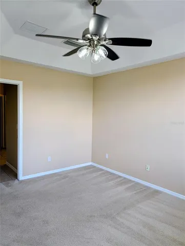 a view of a room with a ceiling fan