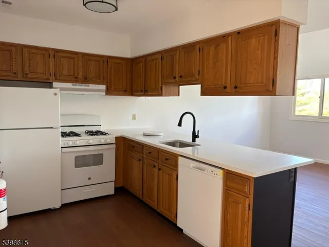 a kitchen with a sink cabinets and appliances