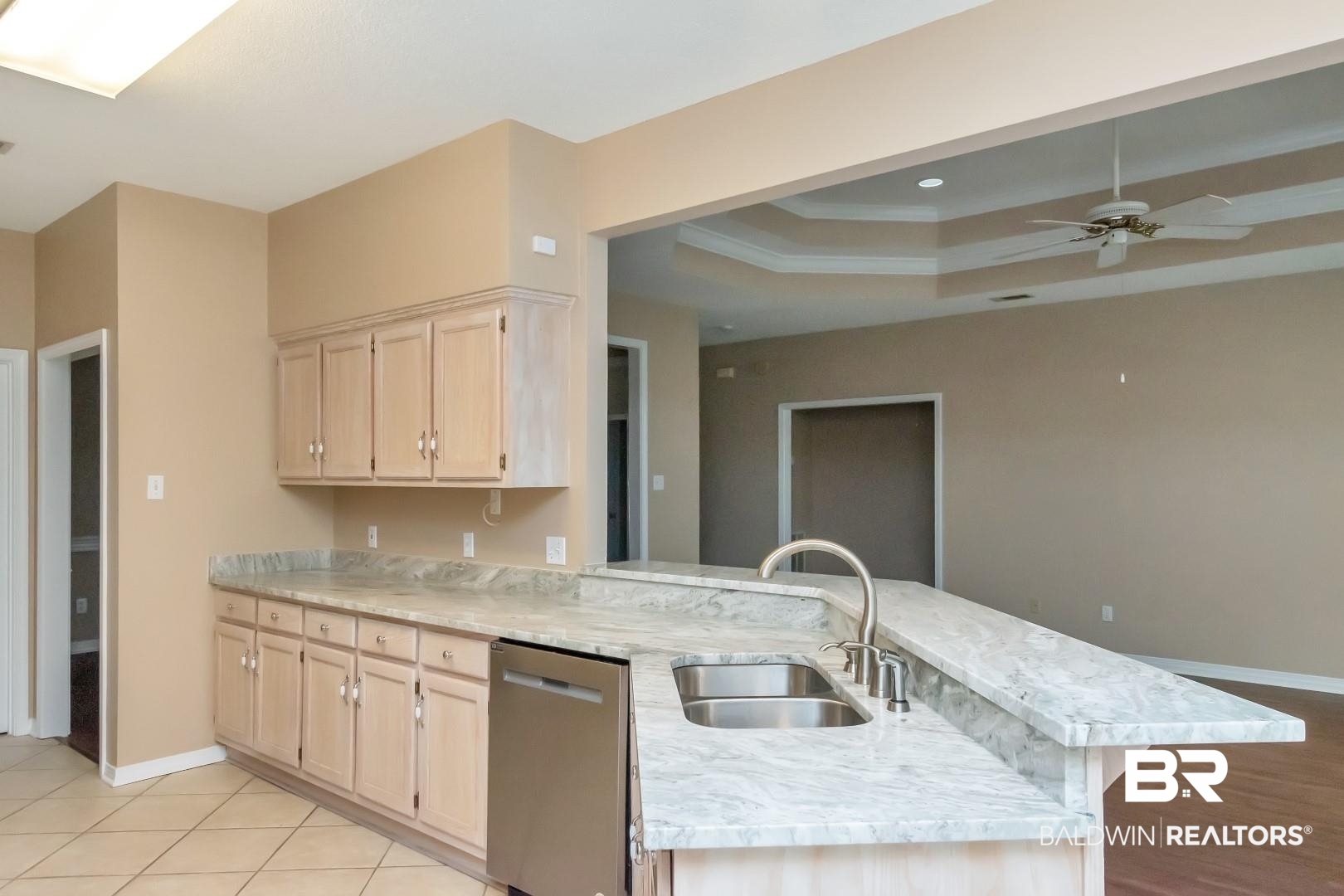6117 Lennox Place Mobile, AL 36693 - Photo 15 of 39 Kitchen featuring light brown cabinets, a sink, a raised ceiling, and dishwasher