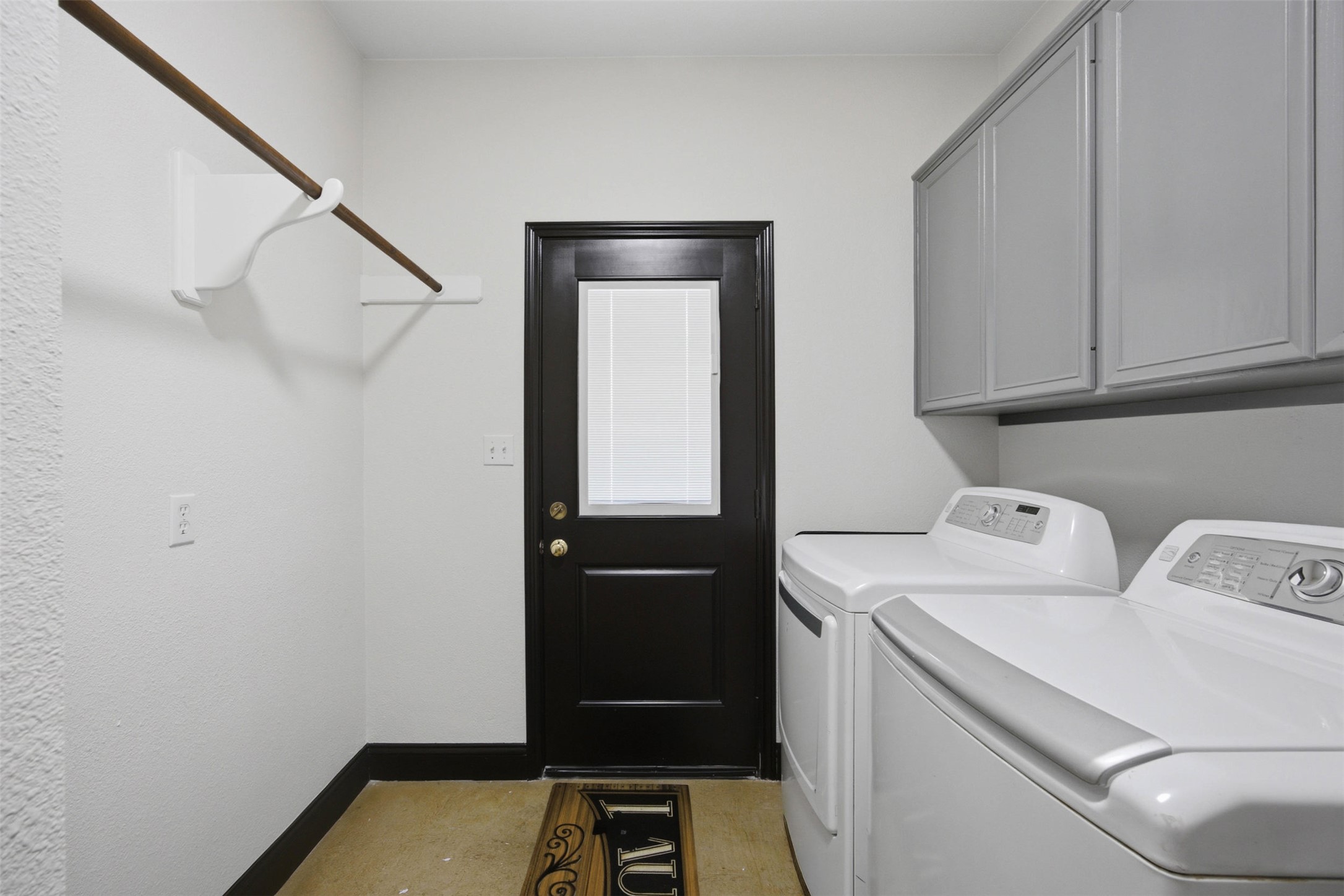720 Spring Creek Road Florence, TX 76527 - Photo 28 of 40 The laundry-mud room is conveniently located between the garage and kitchen, and features a door to the back of the home. It also includes plenty of overhead cabinets and a broom closet.