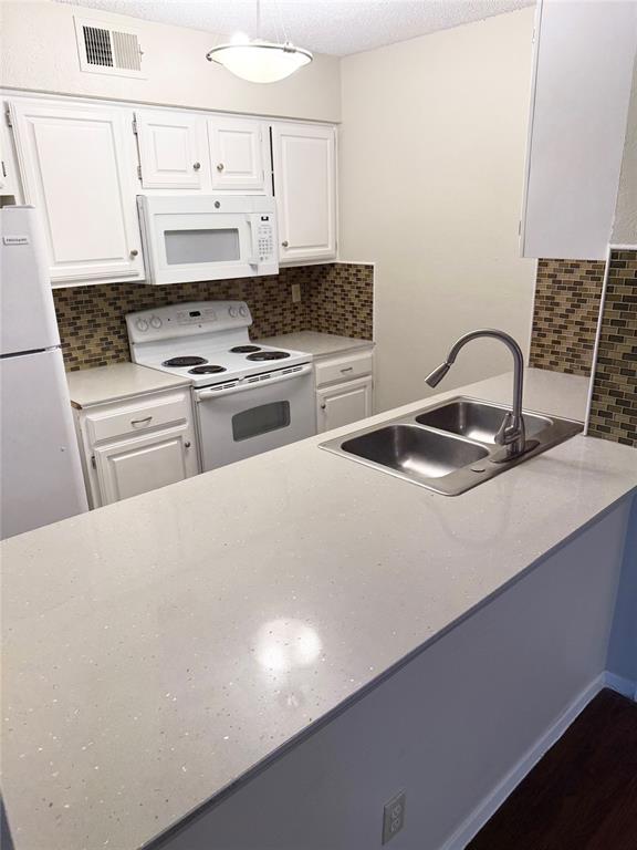 11450 Audelia Road, Unit 304 Dallas, TX 75243 - Photo 2 of 9 a kitchen with stainless steel appliances a sink a stove and a refrigerator