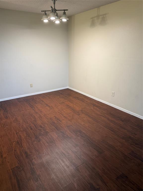 11450 Audelia Road, Unit 304 Dallas, TX 75243 - Photo 3 of 9 an empty room with wooden floor and fan
