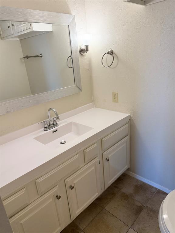 11450 Audelia Road, Unit 304 Dallas, TX 75243 - Photo 4 of 9 a bathroom with a sink vanity and a mirror