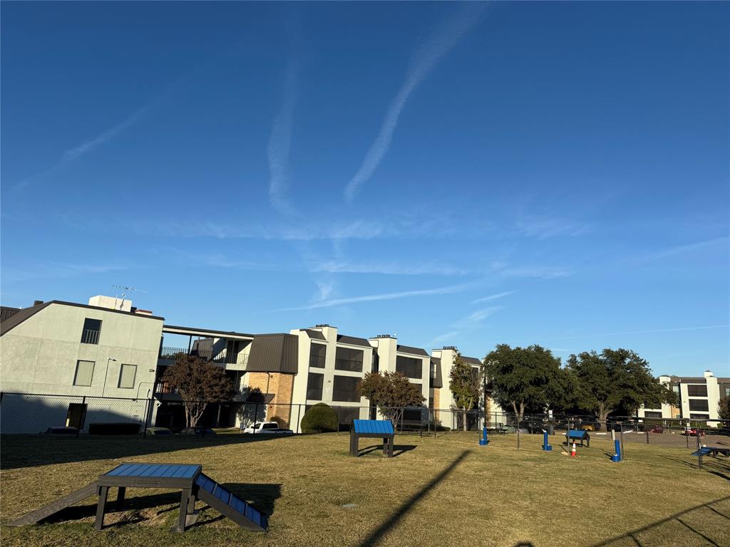11450 Audelia Road, Unit 304 Dallas, TX 75243 - Photo 5 of 9 a view of a building with cars parked