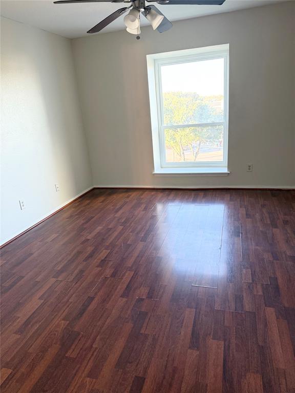 11450 Audelia Road, Unit 304 Dallas, TX 75243 - Photo 7 of 9 an empty room with wooden floor and windows