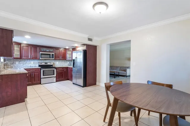 a kitchen with granite countertop a stove microwave and sink