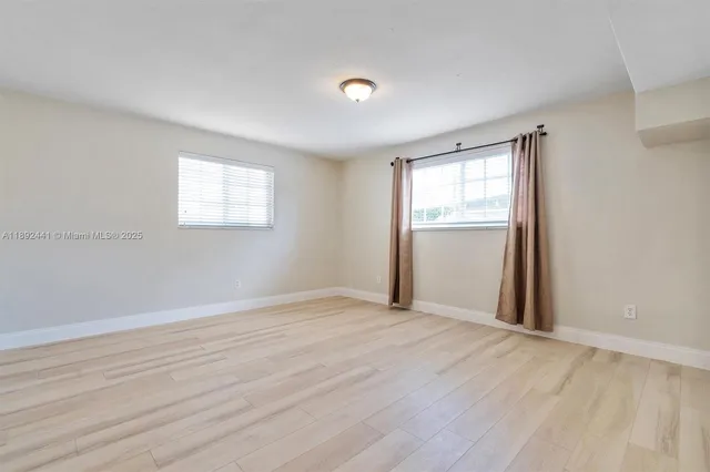 an empty room with windows and closet