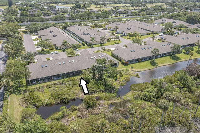 an aerial view of a house with a yard and seating area
