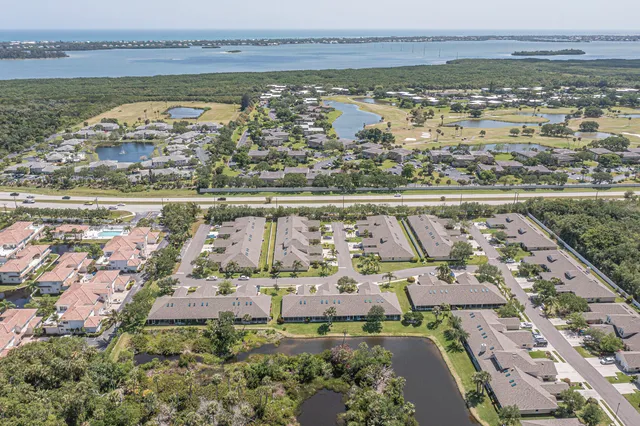 a sign of golf club on a wall under a tree