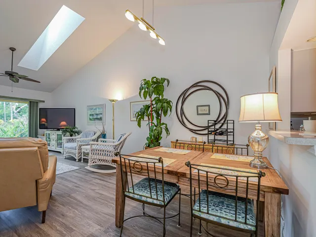 a living room with furniture a mirror and a flat screen tv