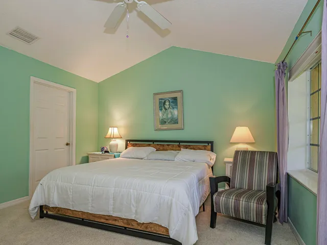 a bedroom with a bed and a lamp