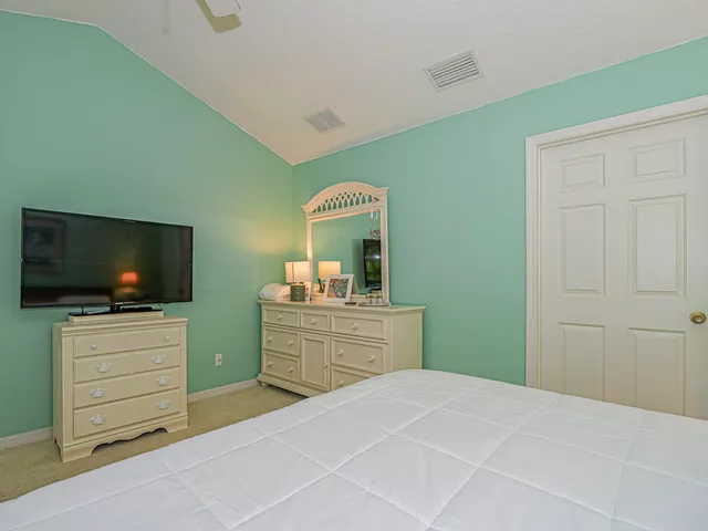 a bedroom with a bed and flat screen tv