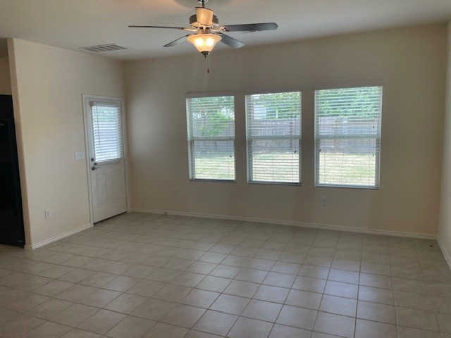 10201 Gertrudis Loop Austin, TX 78747 - Photo 3 of 24 A living space offers a casual, comfortable atmosphere with durable tile flooring and a ceiling fan.