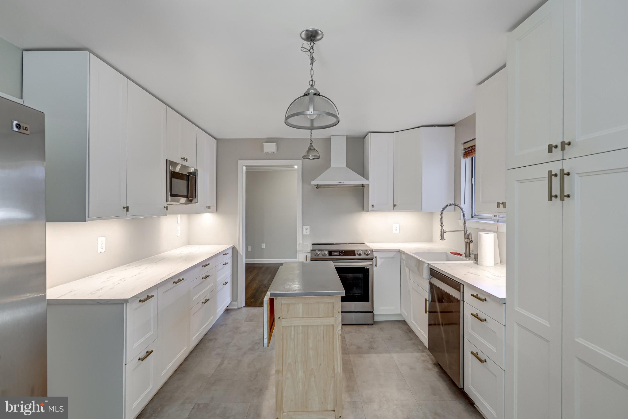 5609 Rolling Road Springfield, VA 22151 - Photo 14 of 42 Modern kitchen with sleek cabinetry and island.