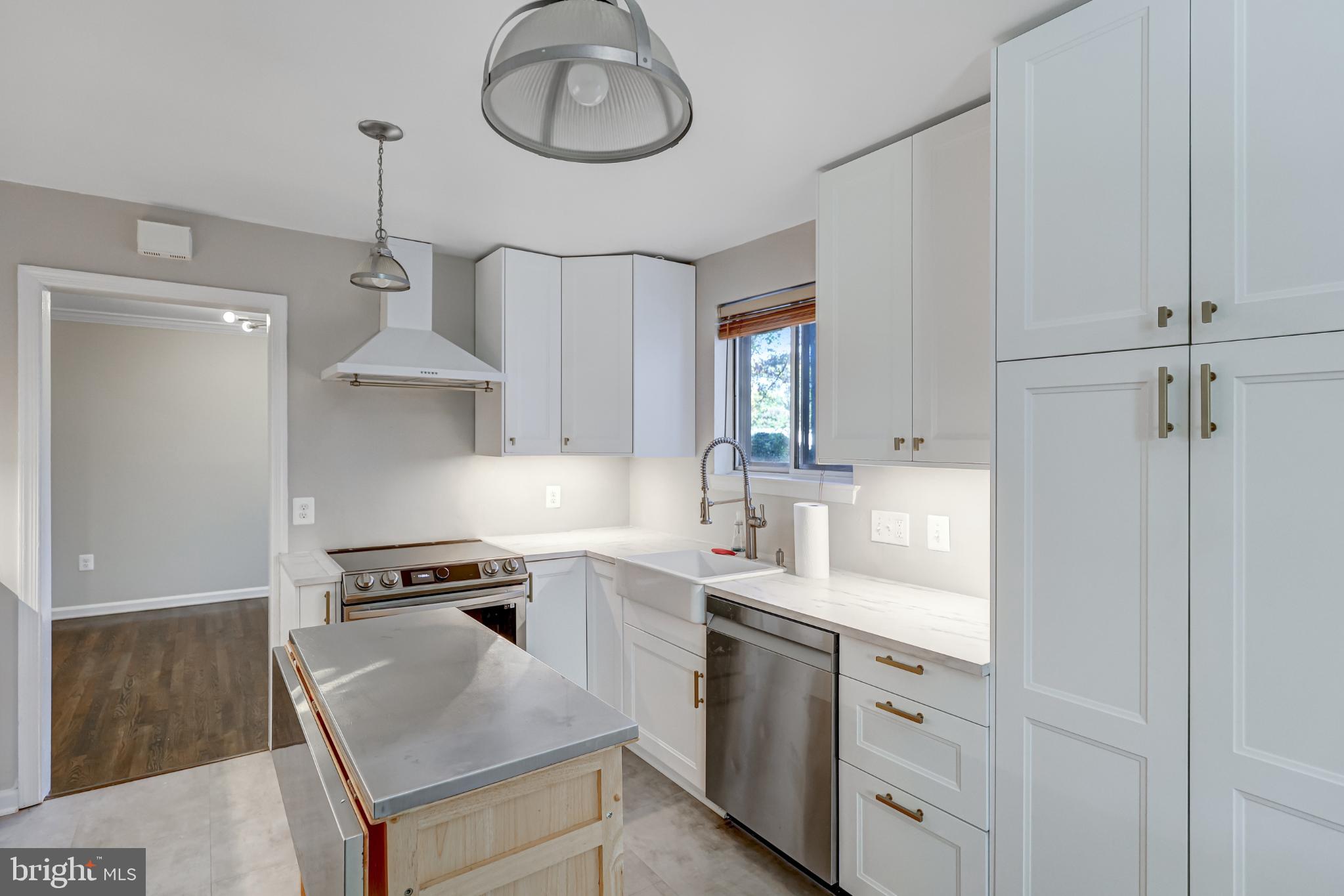 5609 Rolling Road Springfield, VA 22151 - Photo 15 of 42 Modern kitchen with sleek cabinetry and light.