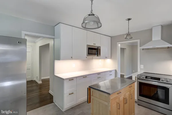 a kitchen with a sink stove and refrigerator
