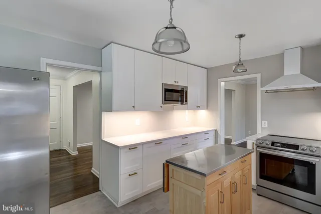 a kitchen with a sink stove and refrigerator