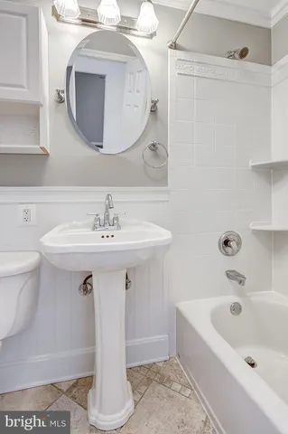 a bathroom with a sink a toilet and bathtub