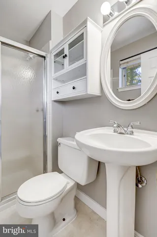 a bathroom with a sink a mirror and a toilet