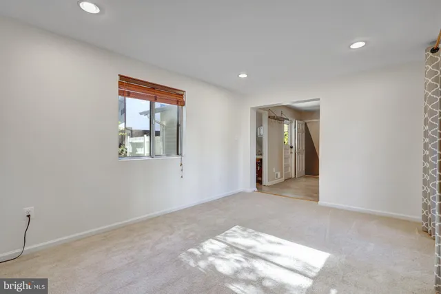 a view of a livingroom with an empty space and window