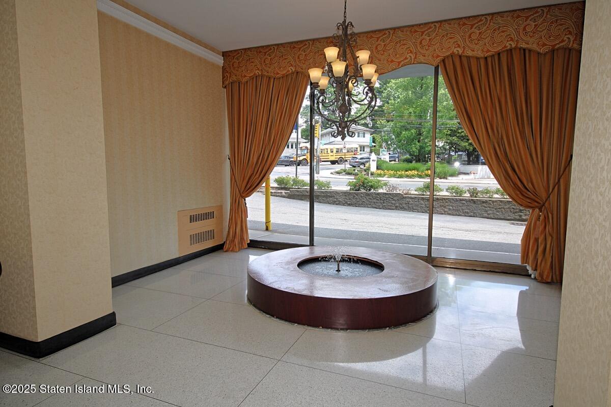 1000 Clove Road, Unit 7G Staten Island, NY 10301 - Photo 14 of 16 a view of a porch with a table and chairs