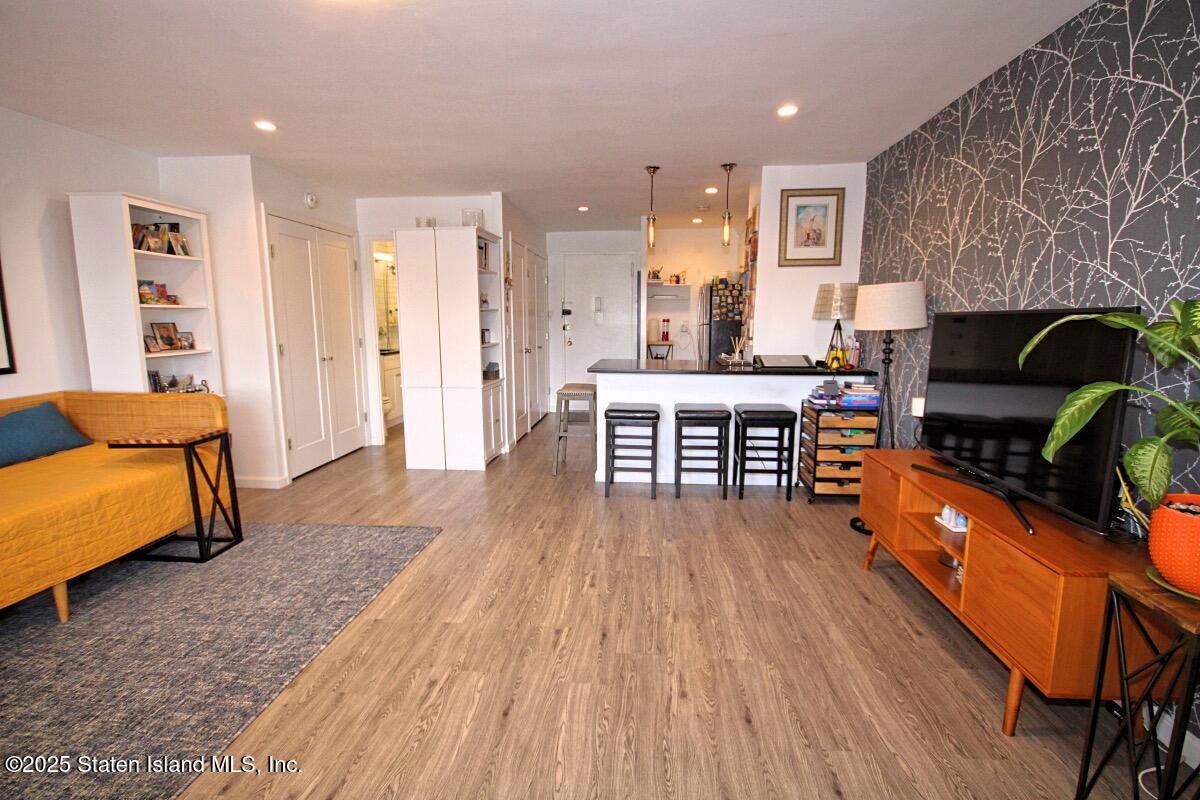 1000 Clove Road, Unit 7G Staten Island, NY 10301 - Photo 3 of 16 a living room with furniture and a wooden floor